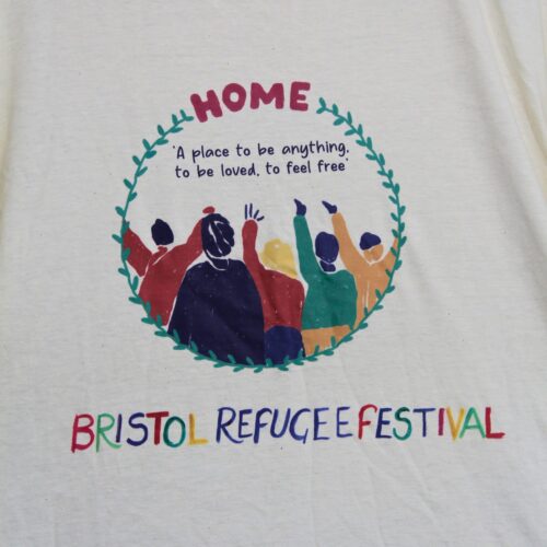 Bristol Refugee Festival 2024 Home T-shirt design, with colourful people surrounded by green leaves.